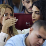 Marwa Fahmy wife of Canadian Al-Jazeera English journalist Mohammed Fahmy, bursts into tears, as she is watched by human rights lawyer Amal Clooney, after the verdict in a courtroom in Tora prison in Cairo, Egypt, Saturday, Aug. 29, 2015. An Egyptian court on Saturday sentenced three Al-Jazeera English journalists to three years in prison, the last twist in a long-running trial criticized worldwide by press freedom advocates and human rights activists. (AP Photo/Amr Nabil)